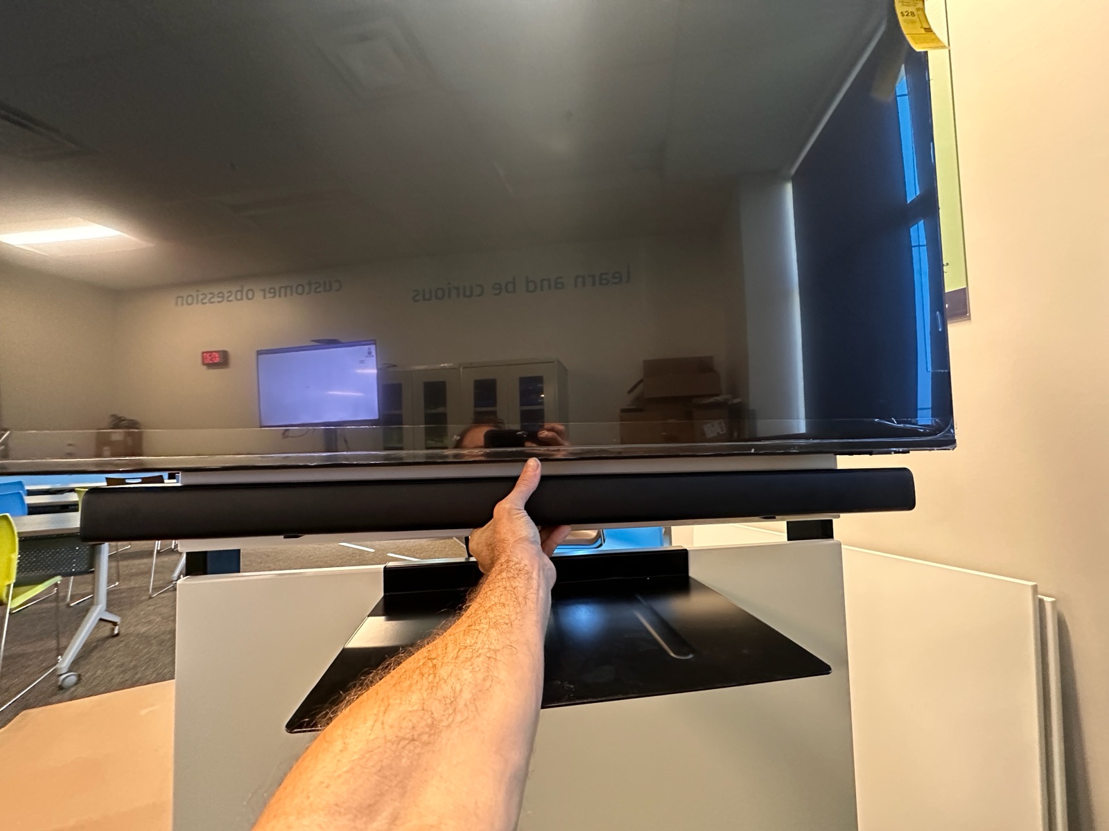 Soundbar and display being fitted during AV cart assembly