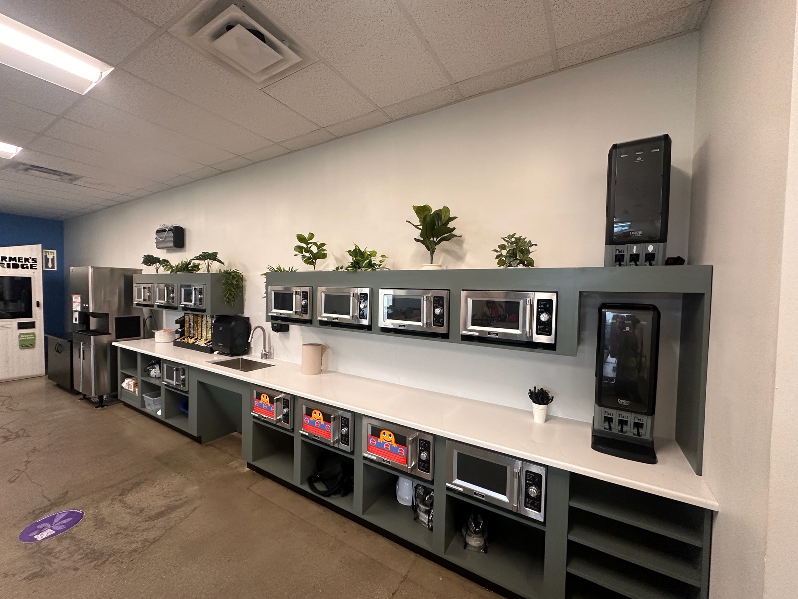 Remodeled break room with custom millwork, quartz counter, microwaves and beverage stations