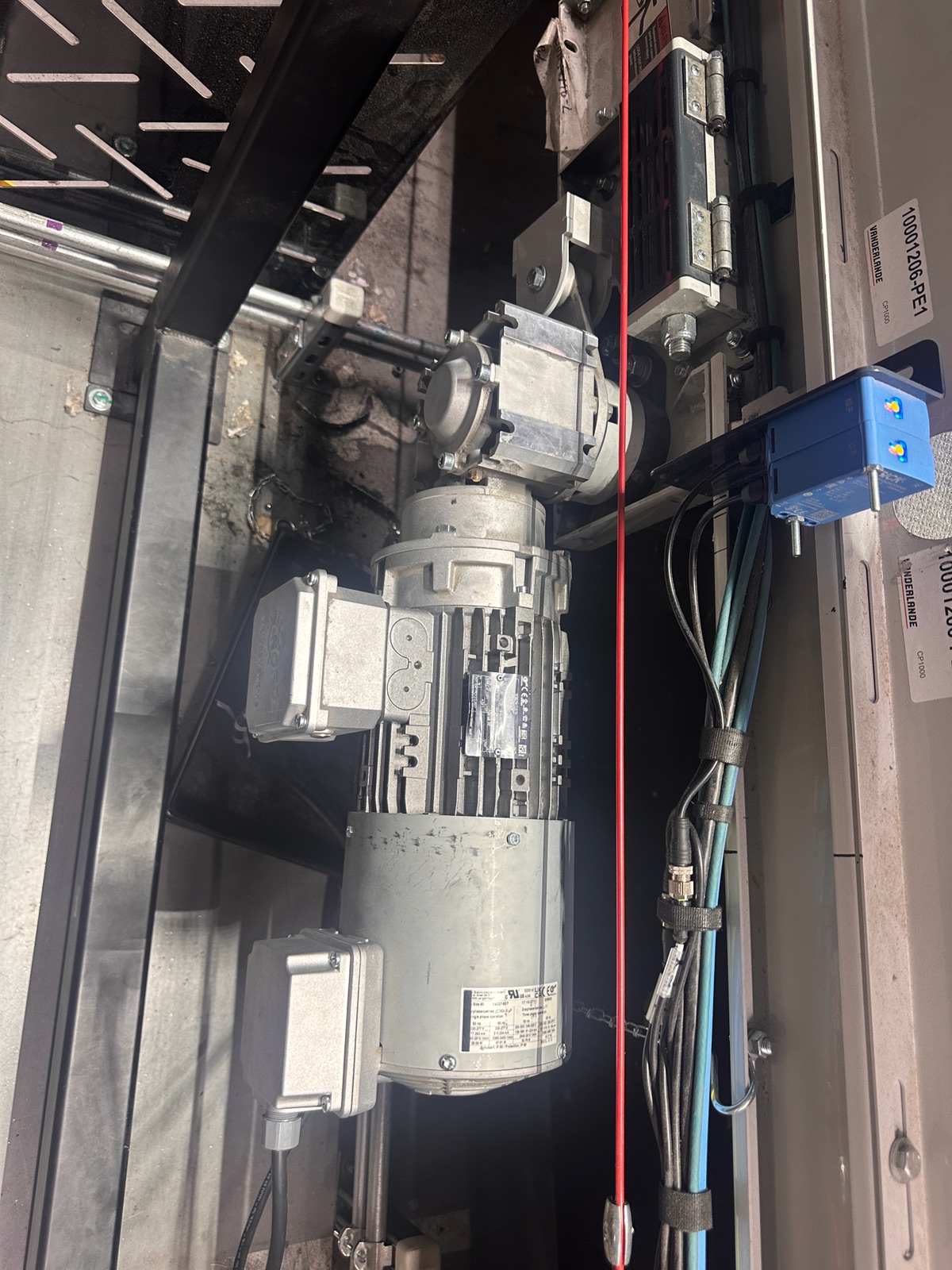 Failed drive motor in place on the conveyor before replacement